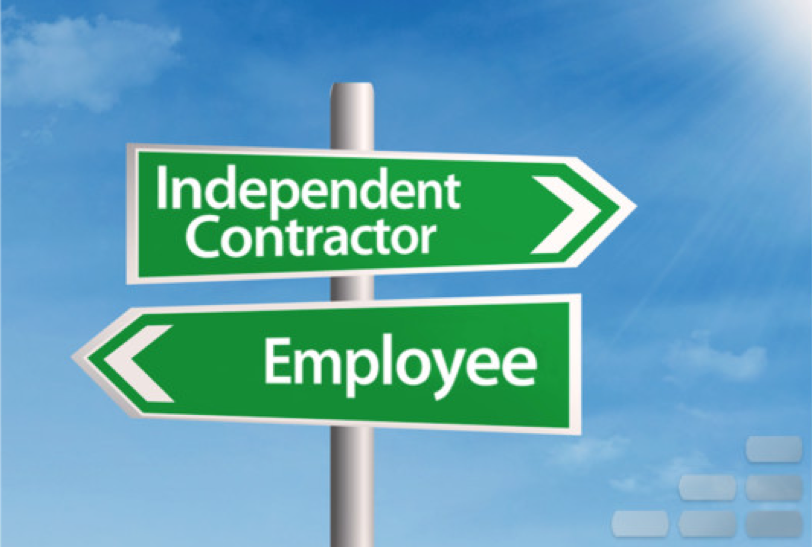 Image of two green signs on a pole. One sign points to the right and says "independent contractor," and the other sign points to the left and says "employee"